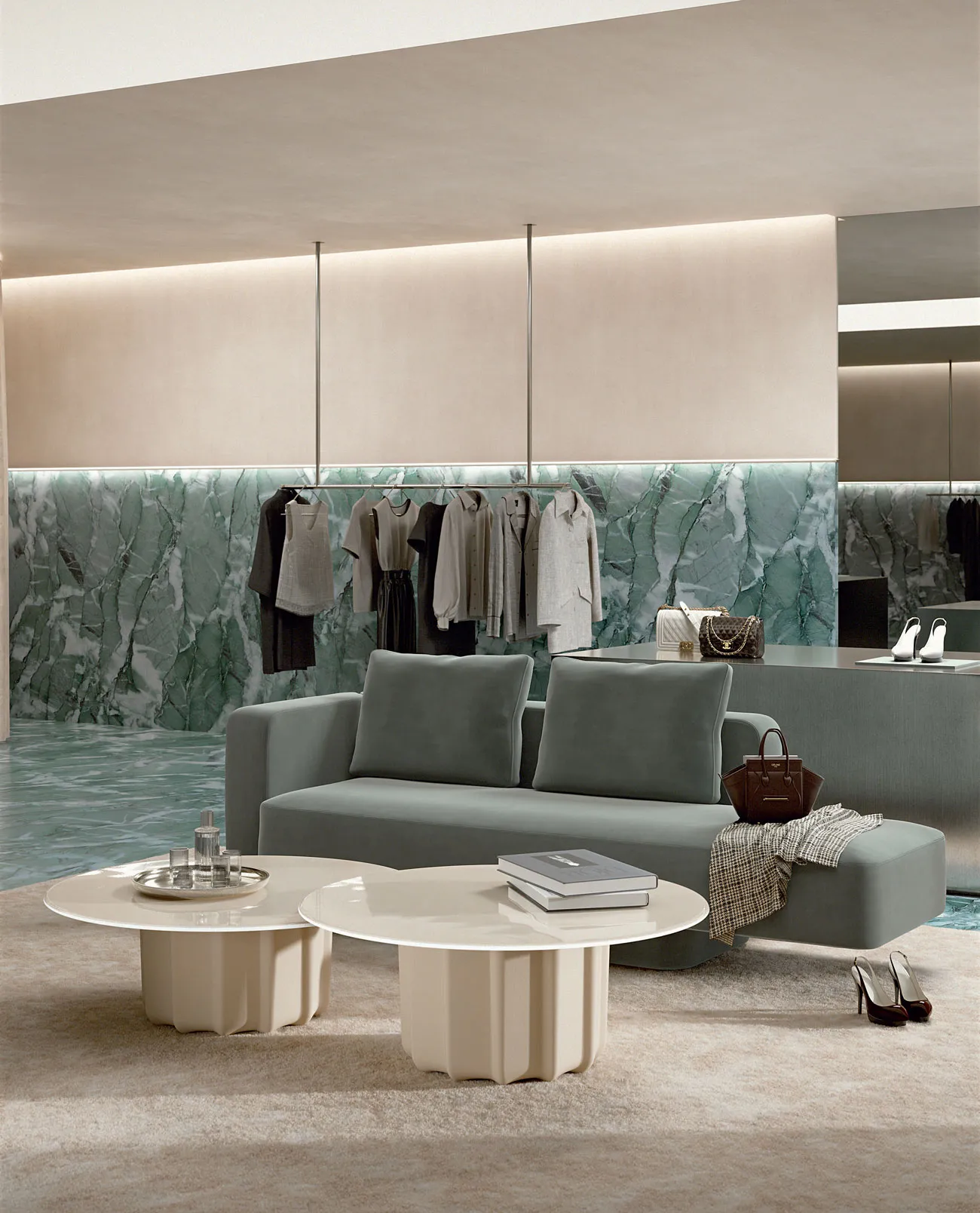 Sabree luxury sofa in sage blue upholstery in a high-end fashion boutique with green marble wall and travertine coffee table — Italian design