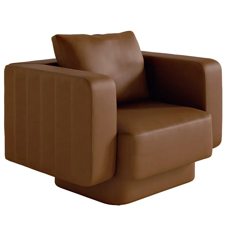 Sabree designer armchair in cognac leather upholstery, three-quarter view showing the signature undulating side panels — Italian design