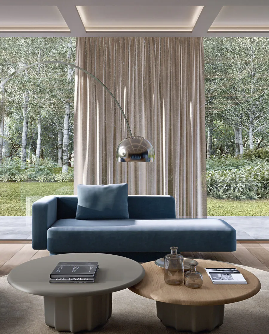 Sabree luxury sofa in teal blue upholstery in a bright contemporary living room with garden view, white linen curtains and oak coffee table — Italian design