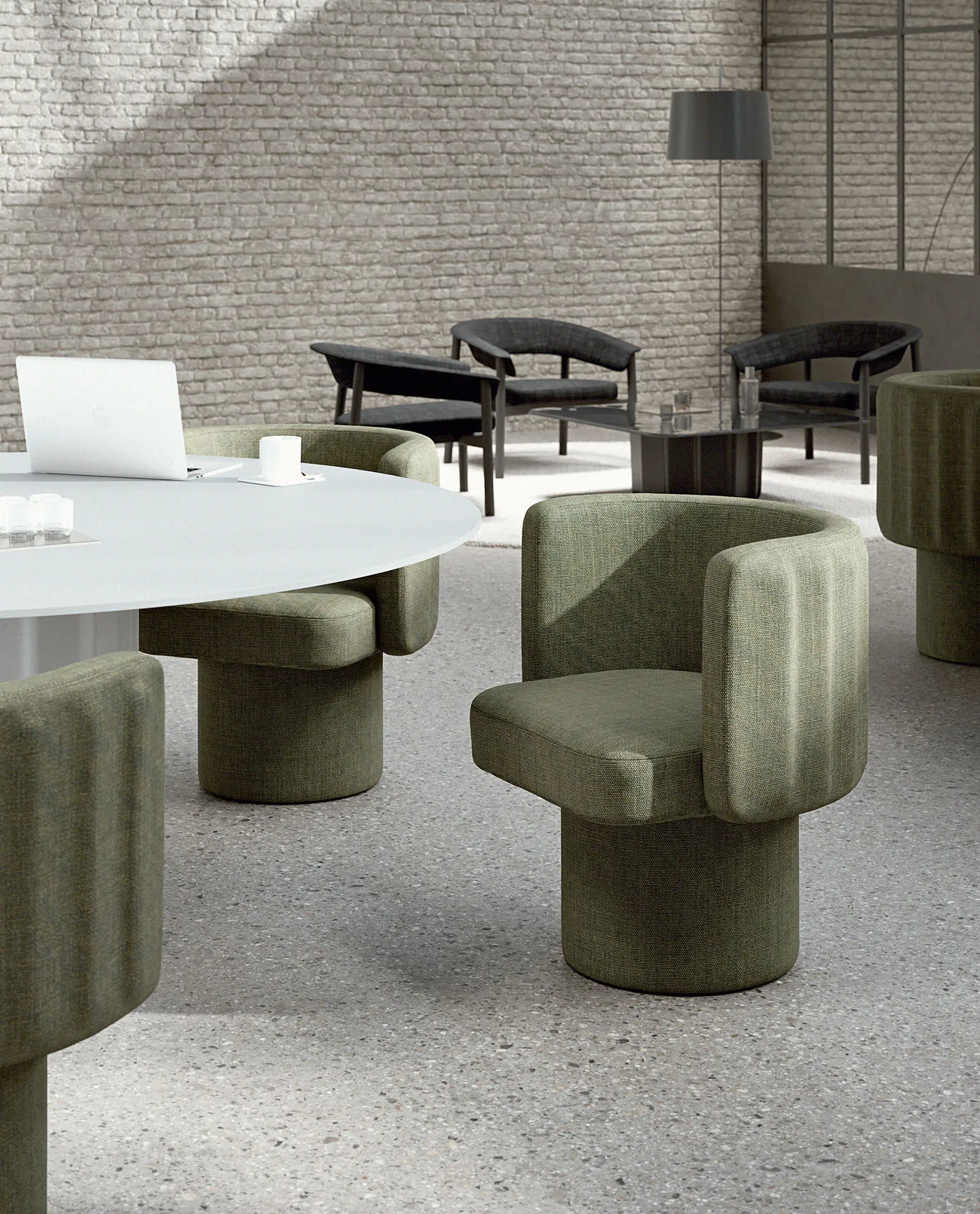 Sabree tub chair in sage green upholstery around a conference table in a contemporary open office with exposed brick wall — Italian design