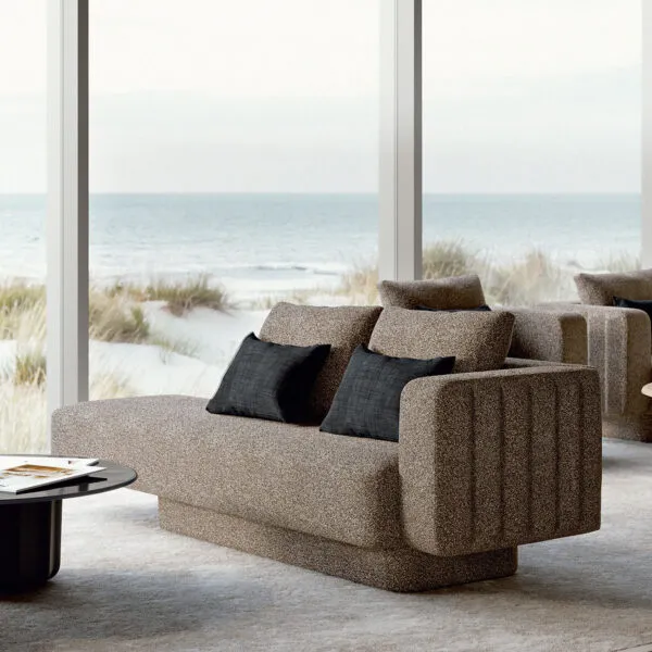 Sabree luxury sofa in taupe upholstery with blue cushions in a coastal living room with floor-to-ceiling windows and sea view — Italian design