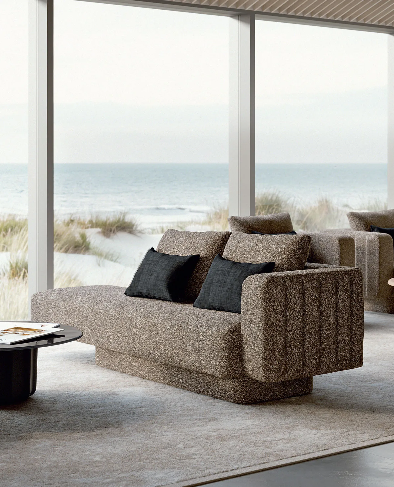 Sabree luxury sofa in taupe upholstery with blue cushions in a coastal living room with floor-to-ceiling windows and sea view — Italian design