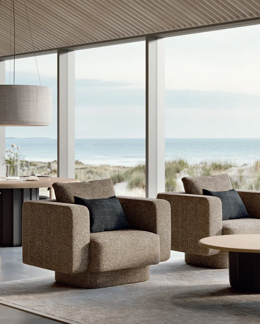 Sabree luxury sofa in taupe upholstery with blue cushions in a coastal living room with floor-to-ceiling windows and sea view — Italian design