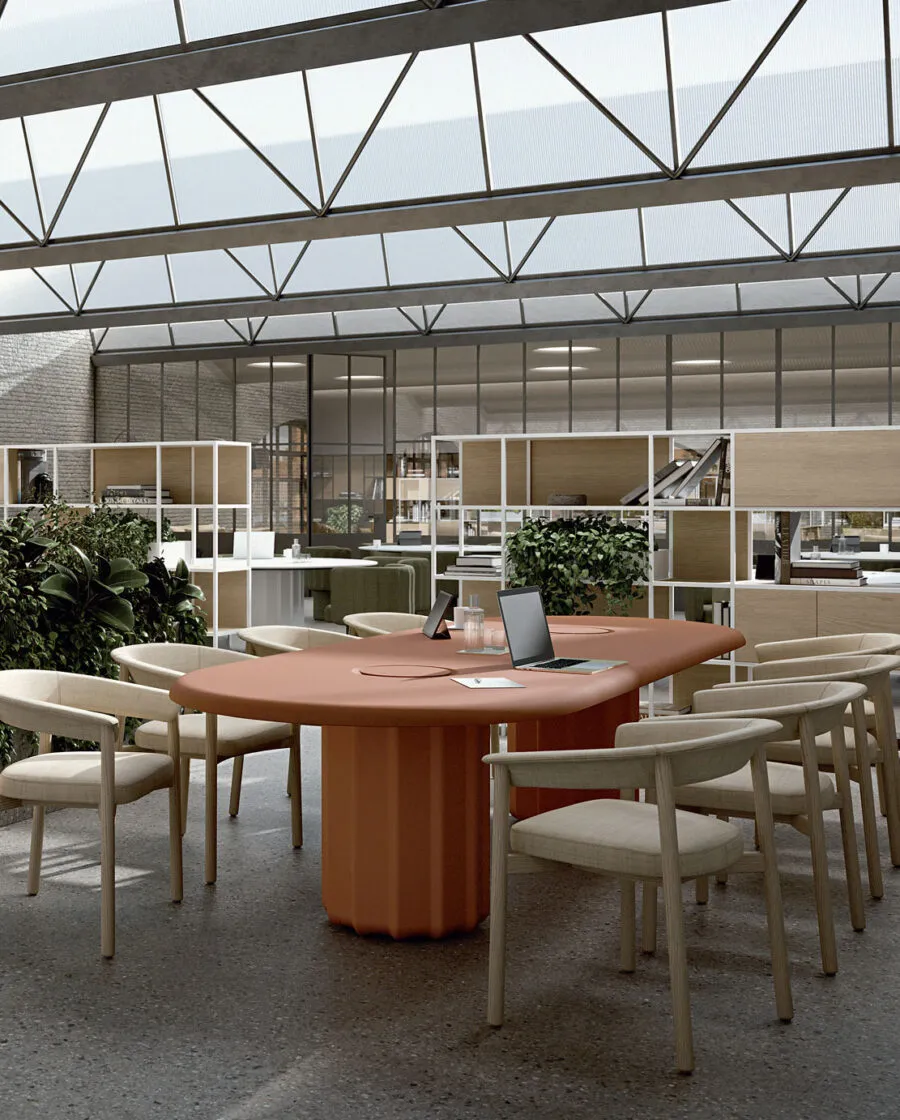 Sabree oval table design with terracotta bases paired with Lash chairs in a co-working loft with glass roof and modular shelving — Frezza contract