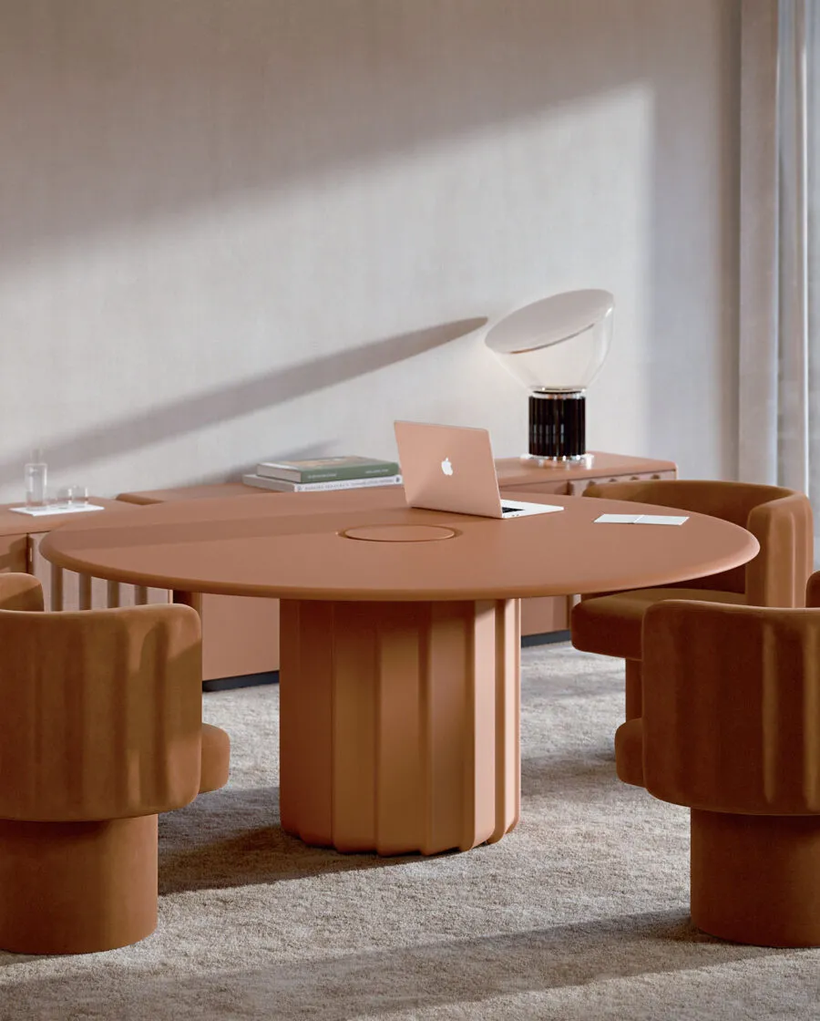 Sabree round table design with sculptural wave base in terracotta finish, surrounded by Lash chairs in a minimal executive setting with natural light — Frezza
